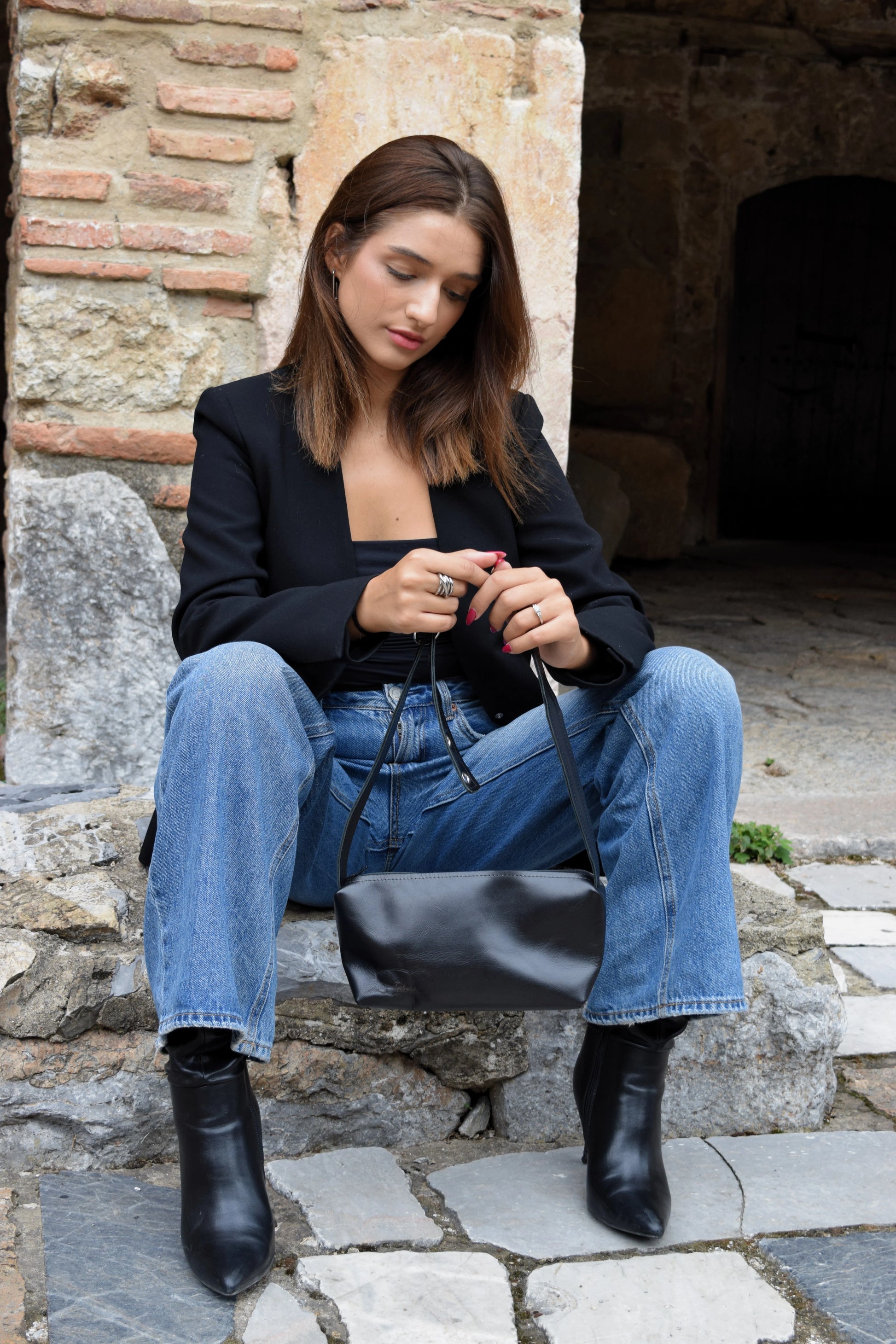 Black goat leather bag that embodies luxury and compassion with the black closure personally handcrafted by Santebela team