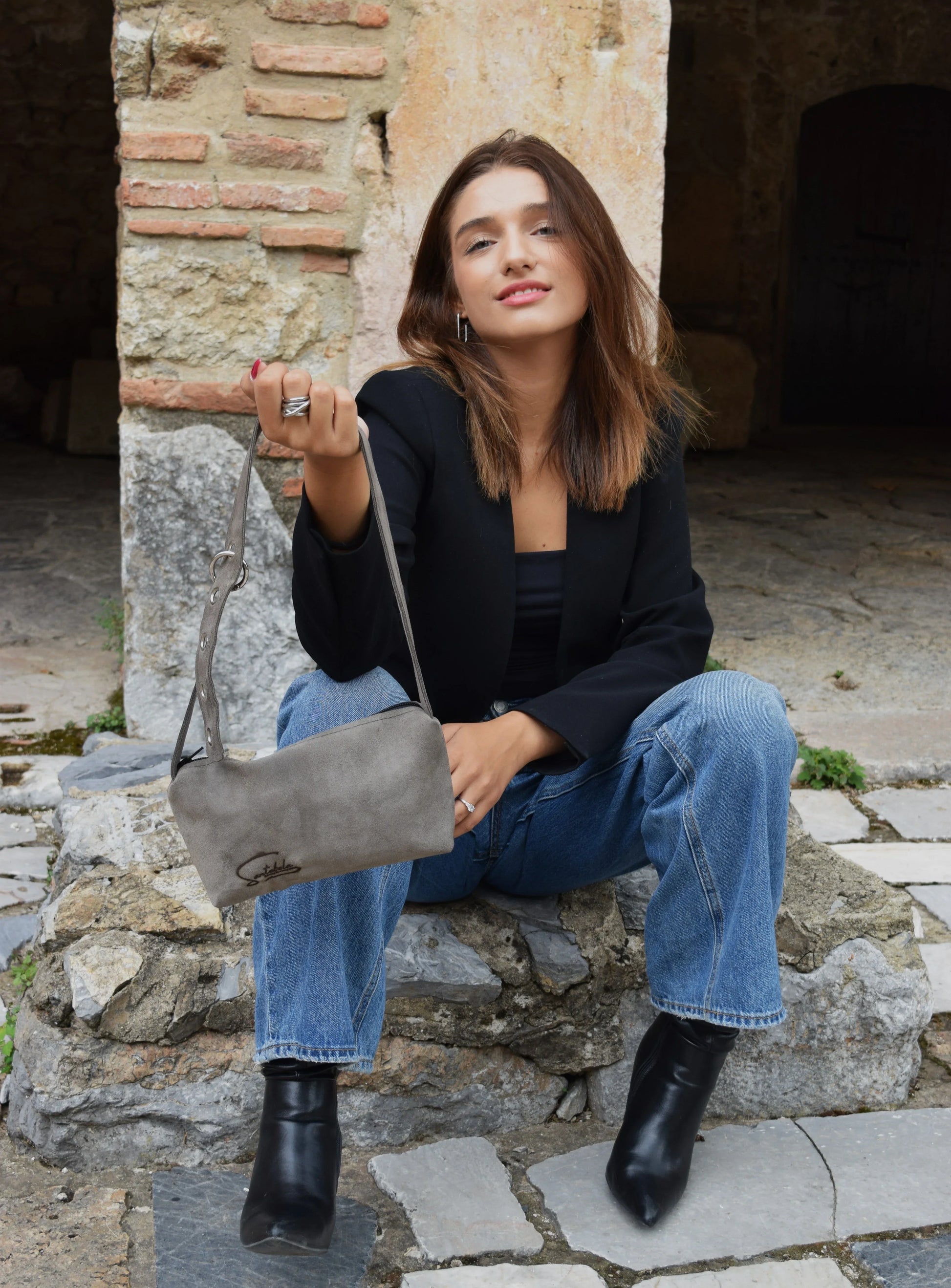 Model showcasing the Gray Luna crossbody bag with adjustable strap.