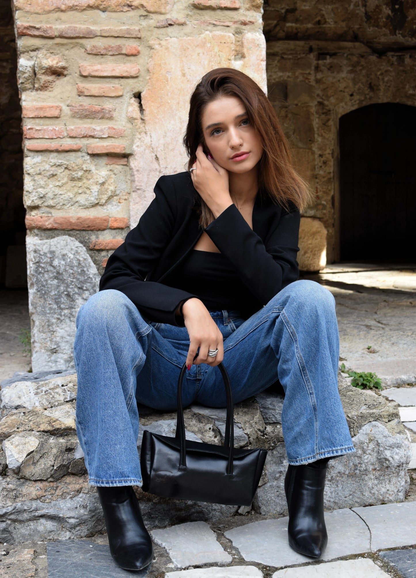 Model presenting the fiera black goat leather back crafted carefully by Santebela
