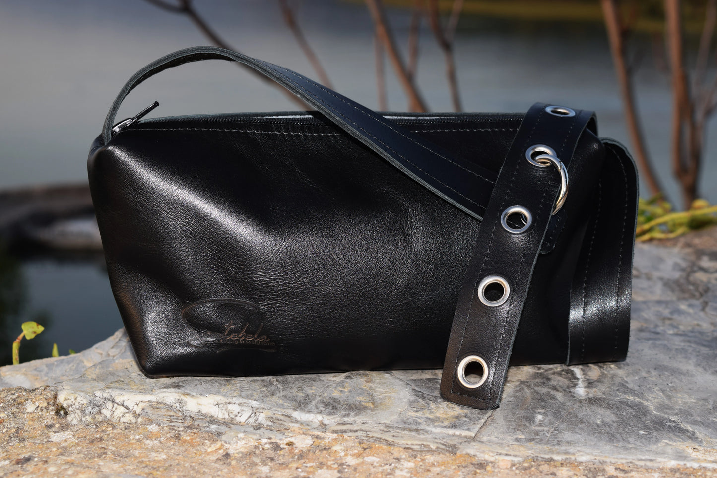 Black Italian leather bag with small detailing that embodies luxury and compassion  personally handcrafted by Santebela team