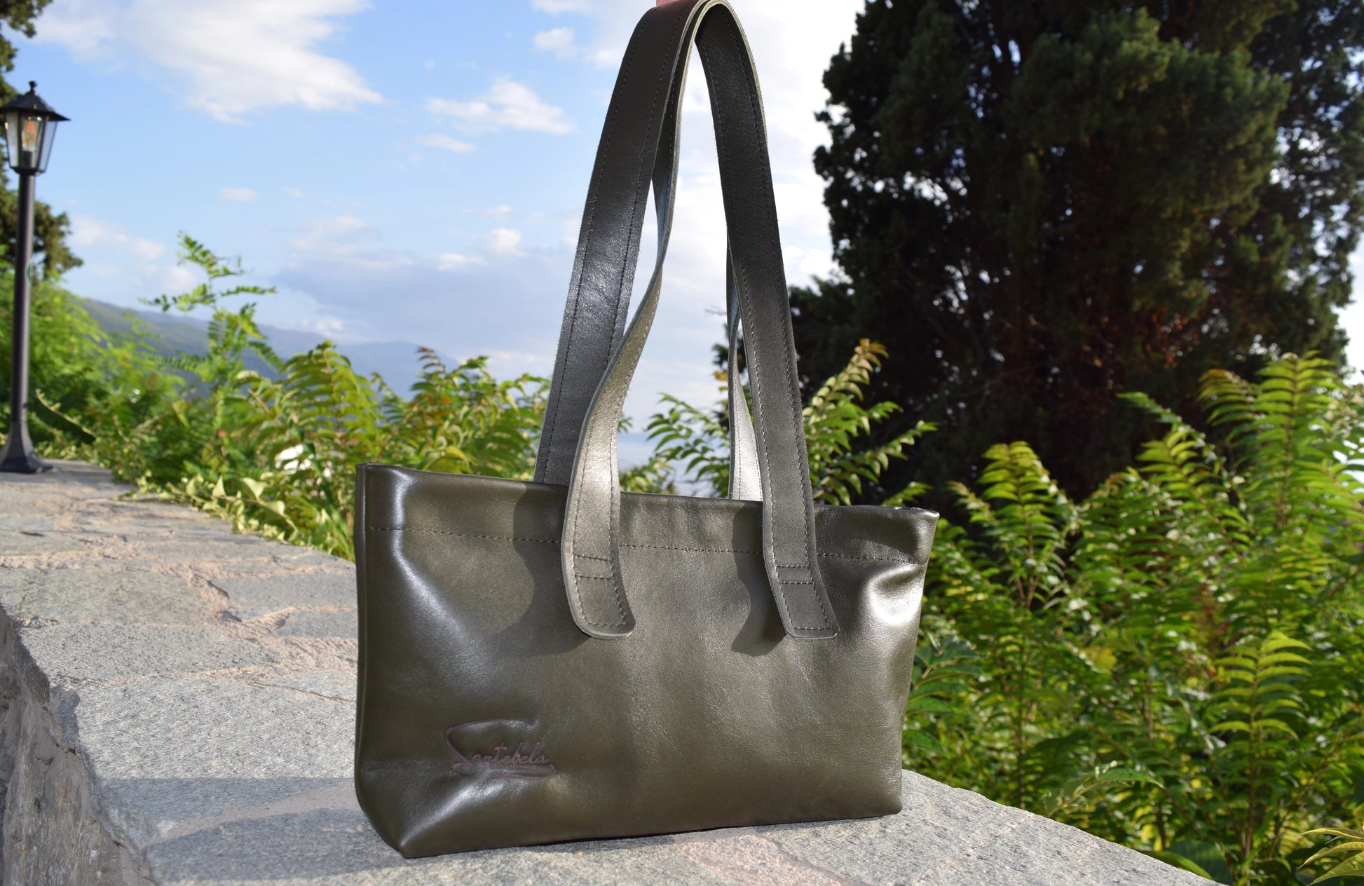 Dark Green Olive Leather Tote Bag, front view, crafted from supple Italian calfskin with polished silver magnets and black stitching by Santebela.