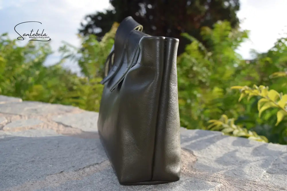 Side profile of the Dark Green Olive Leather Tote Bag, highlighting structured silhouette and precise black stitching by Santebela